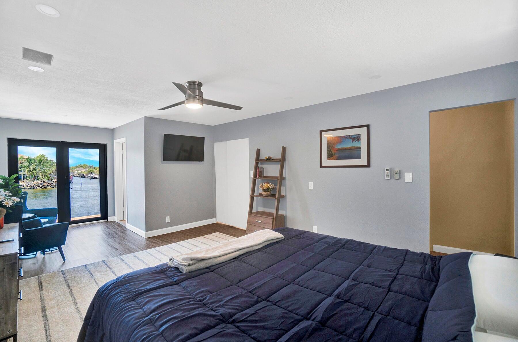 1901 North Riverside Drive, Unit 1 Pompano Beach, FL 33062 - Photo 15 of 26 a bedroom with a large bed and a window