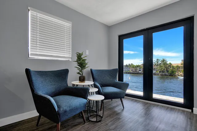 a view of a livingroom with furniture wooden floor and a window