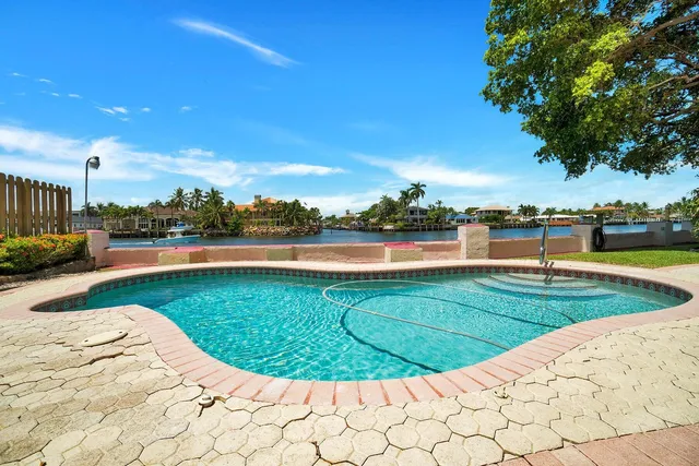 a view of a swimming pool and a yard