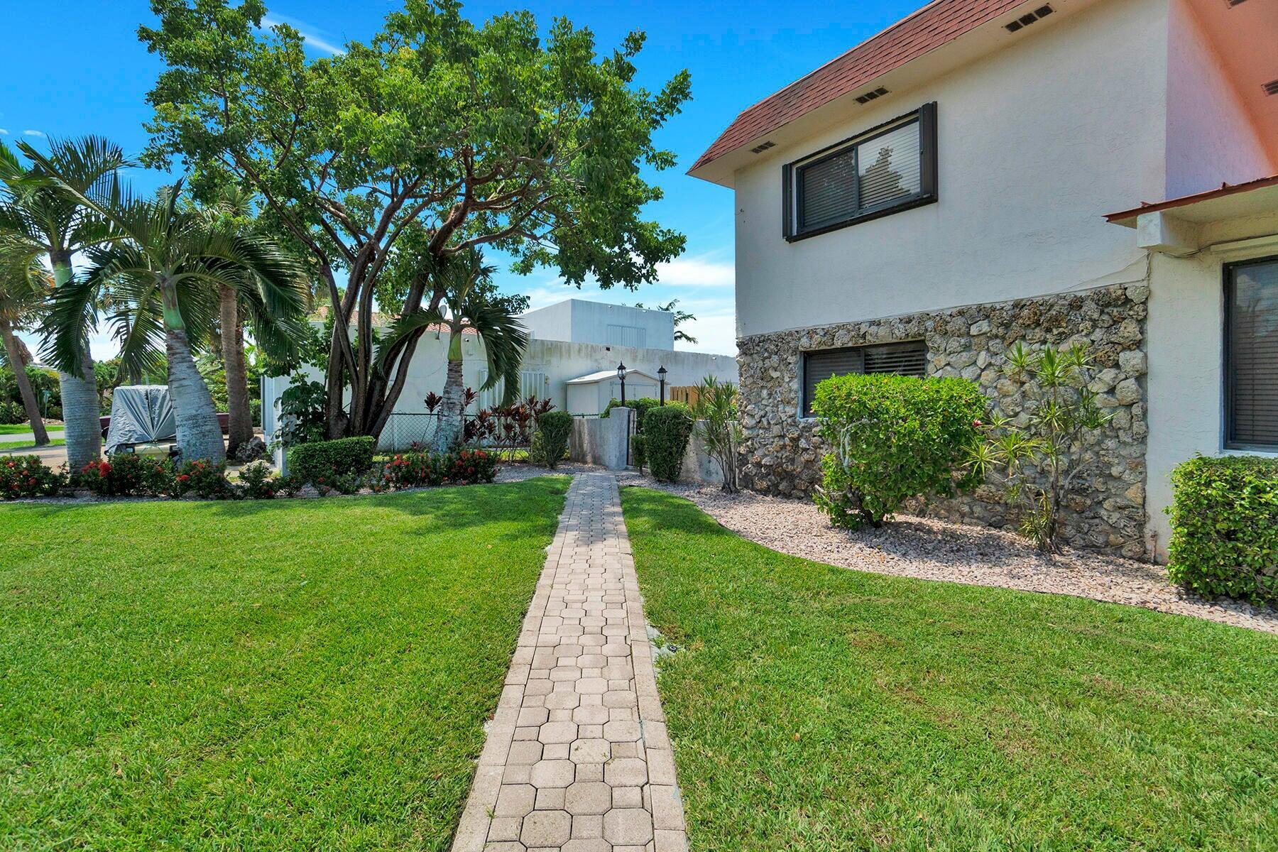 1901 North Riverside Drive, Unit 1 Pompano Beach, FL 33062 - Photo 9 of 26 a front view of a house with a yard