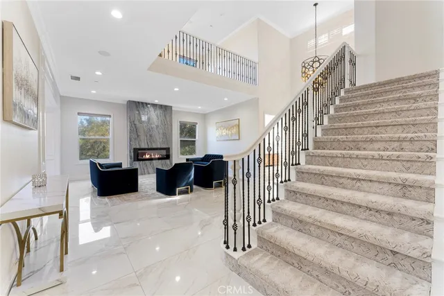 a view of a hallway with wooden floor and windows