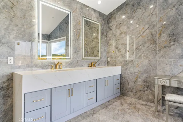 a bathroom with a sink vanity granite and a mirror