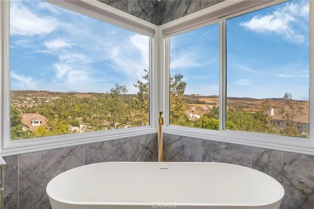 a view of walk in closet with white walls