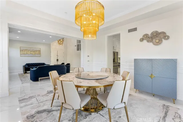 a view of a dining room with a table and chairs
