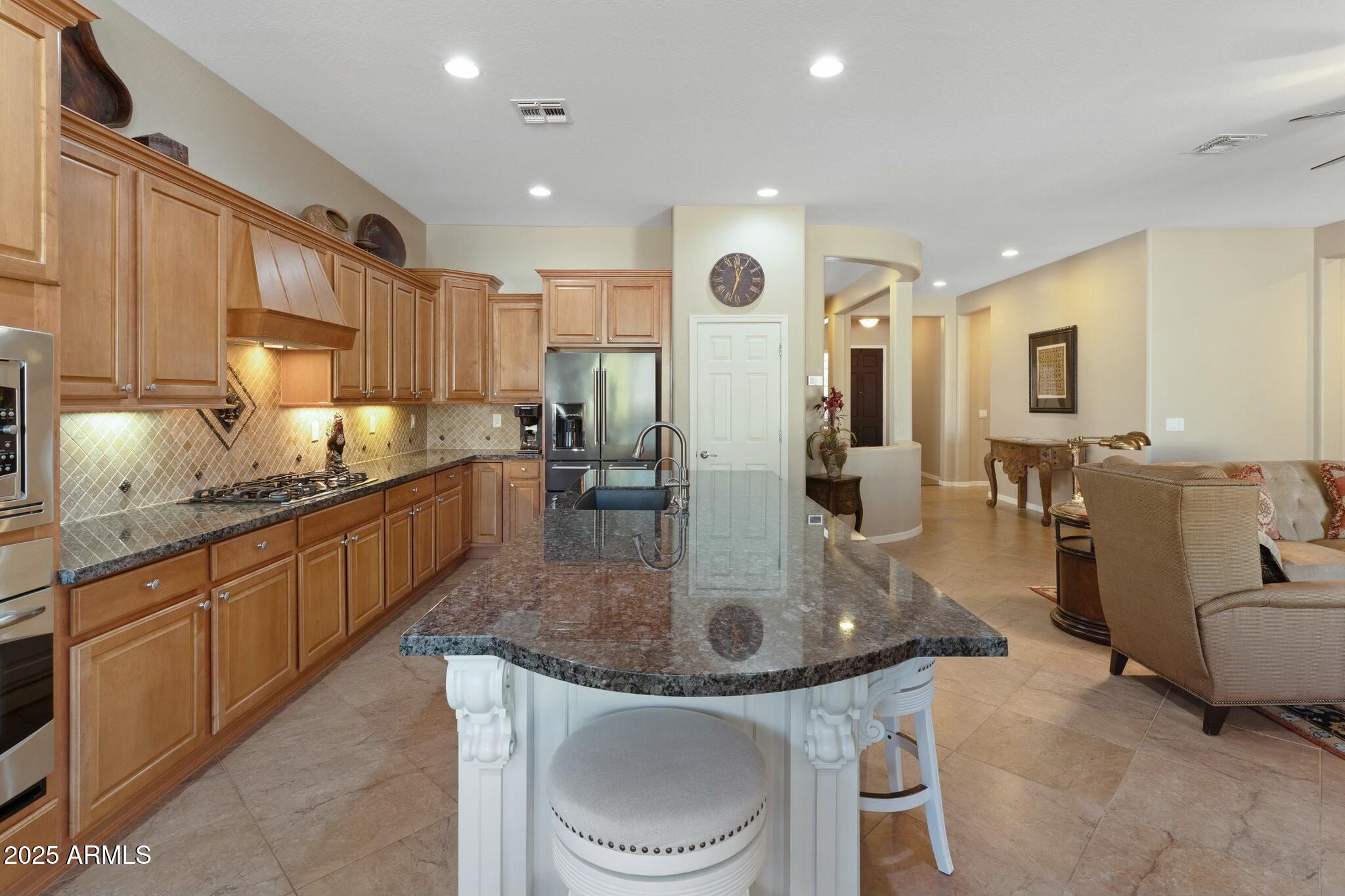 2022 West Steed Ridge Phoenix, AZ 85085 - Photo 11 of 85 a kitchen with stainless steel appliances granite countertop a sink a stove and a refrigerator