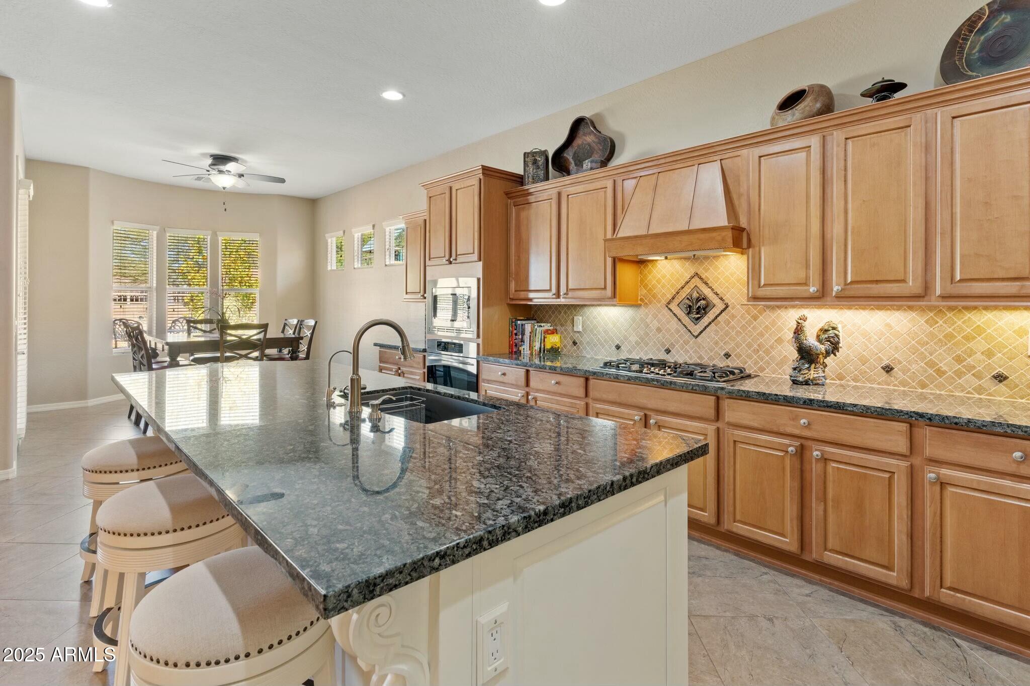 2022 West Steed Ridge Phoenix, AZ 85085 - Photo 13 of 85 a kitchen with granite countertop a sink a stove and cabinets