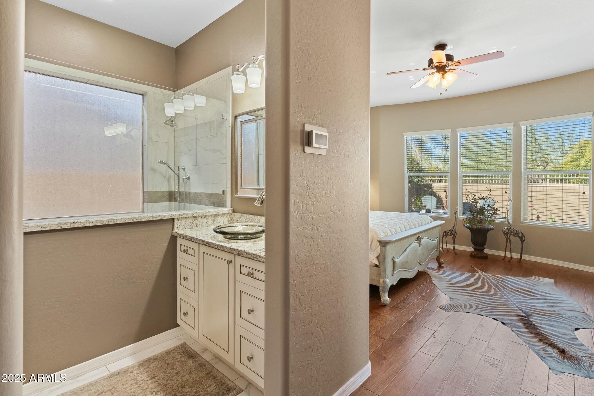 2022 West Steed Ridge Phoenix, AZ 85085 - Photo 21 of 85 a spacious bathroom with a granite countertop sink a toilet and a bathtub