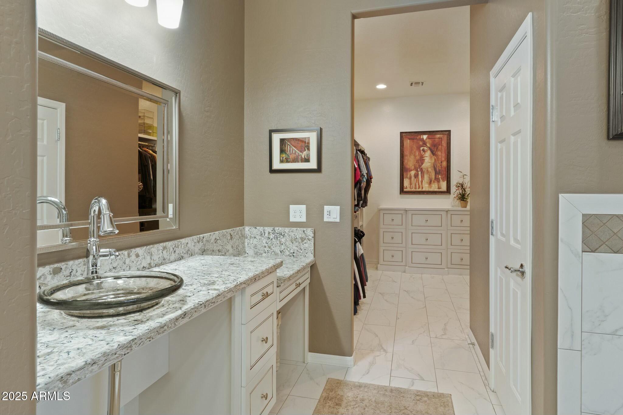 2022 West Steed Ridge Phoenix, AZ 85085 - Photo 22 of 85 a bathroom with a granite countertop sink a mirror and a shower