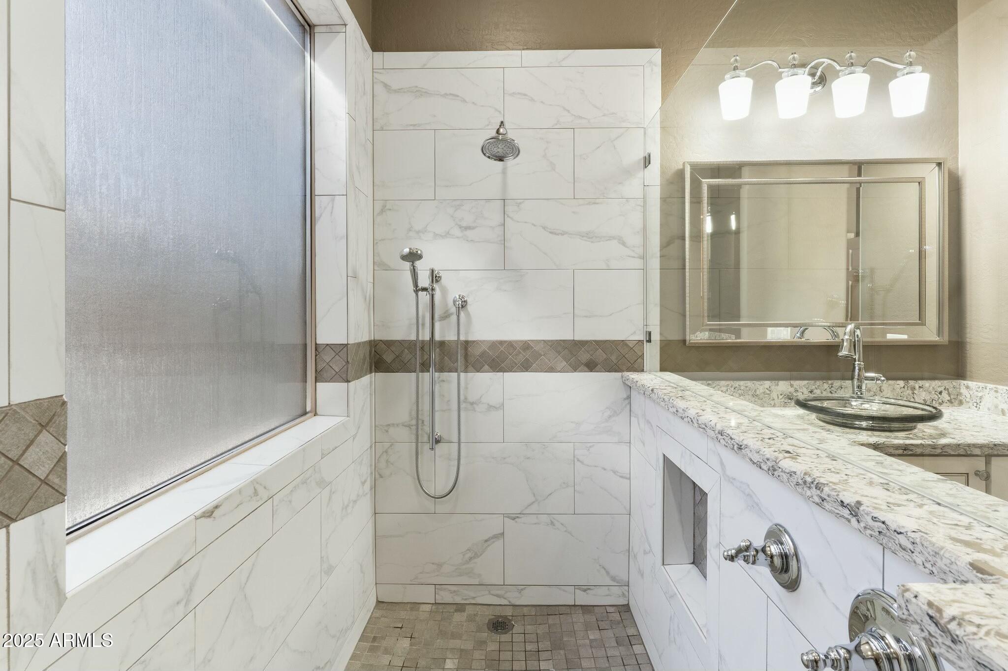 2022 West Steed Ridge Phoenix, AZ 85085 - Photo 24 of 85 a bathroom with a granite countertop sink a mirror and a shower