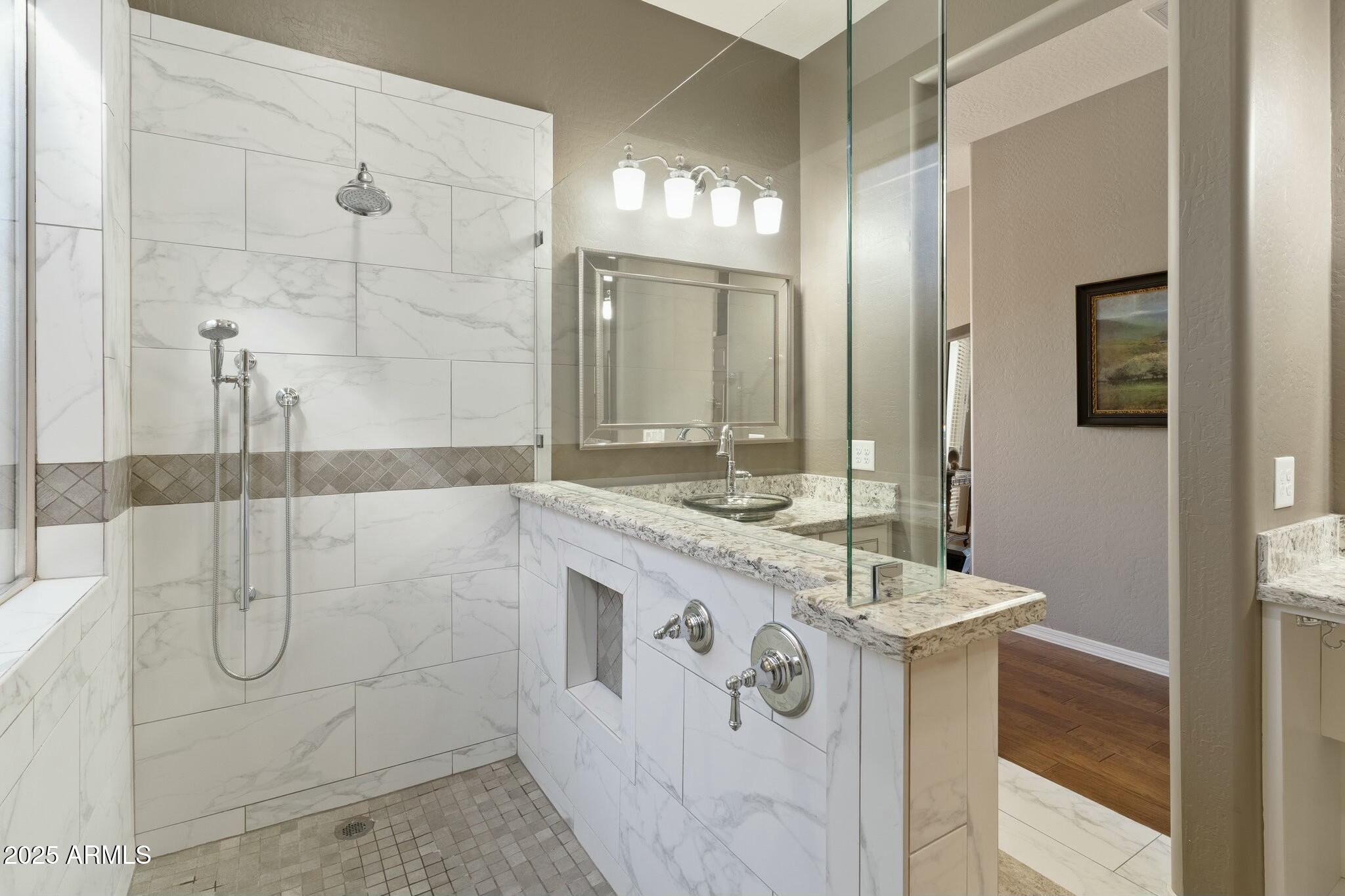 2022 West Steed Ridge Phoenix, AZ 85085 - Photo 25 of 85 a bathroom with a granite countertop sink a mirror and a shower