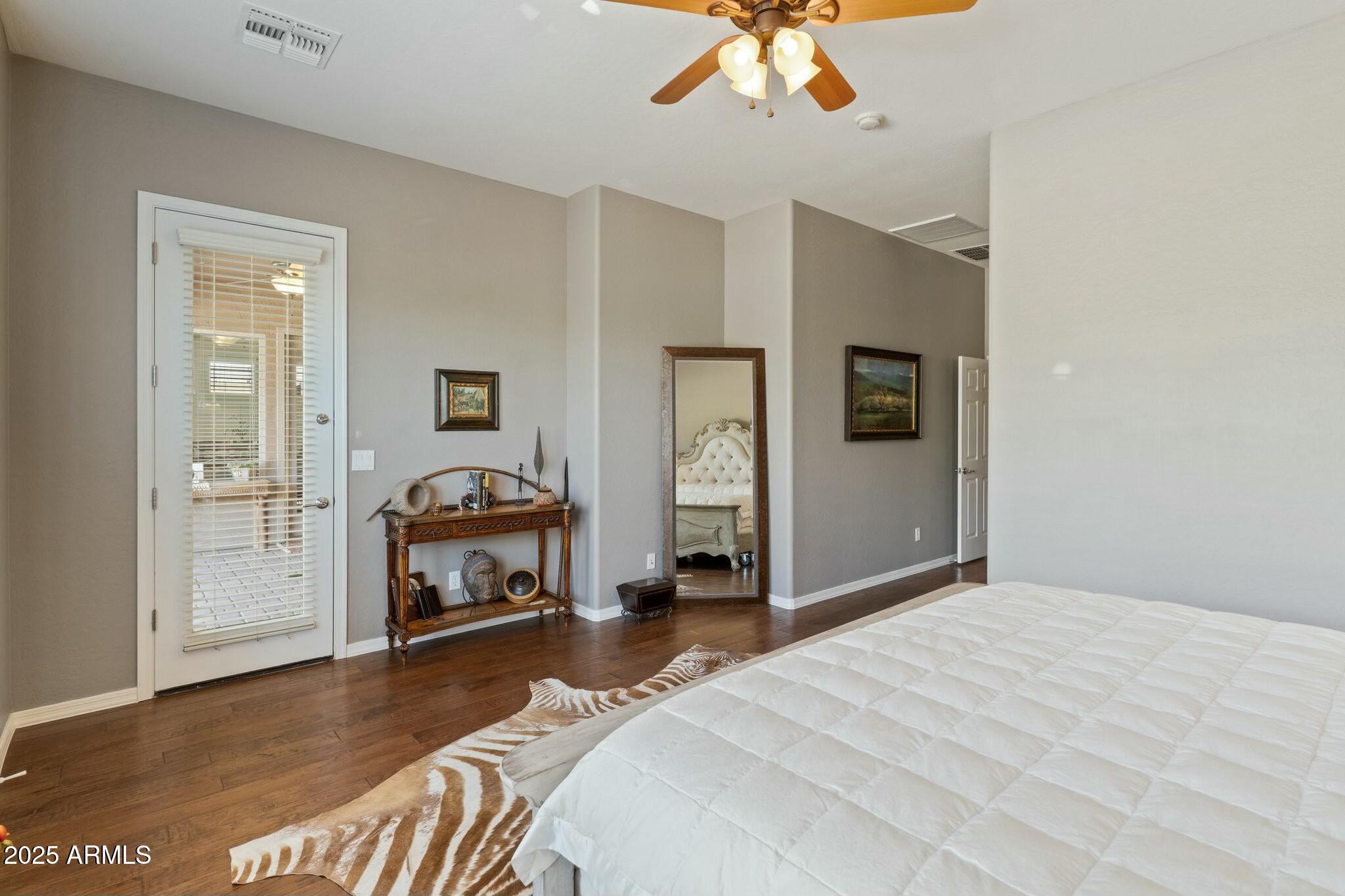 2022 West Steed Ridge Phoenix, AZ 85085 - Photo 31 of 85 a bedroom with a bed and a chandelier