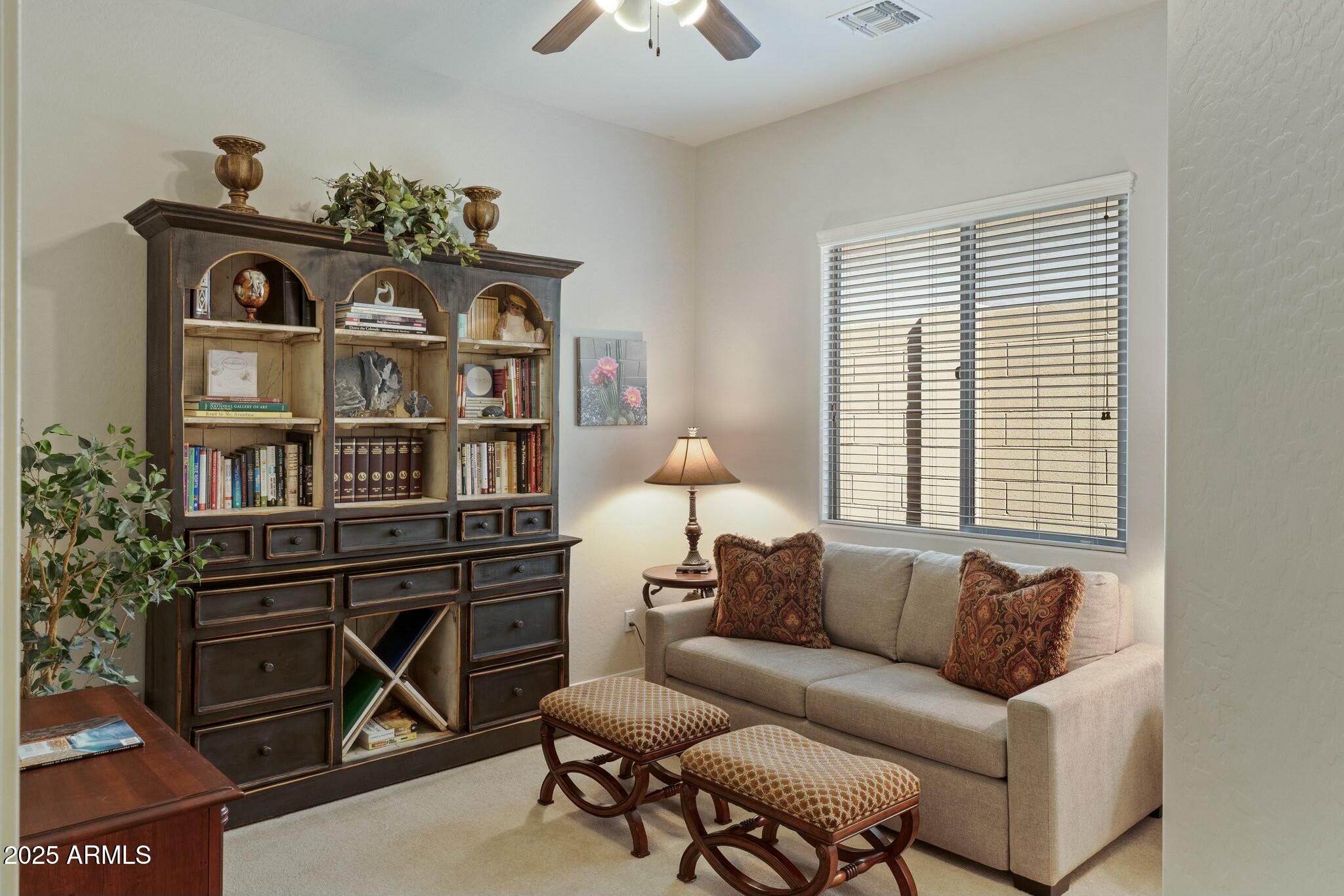 2022 West Steed Ridge Phoenix, AZ 85085 - Photo 38 of 85 a living room with furniture a chandelier and a window