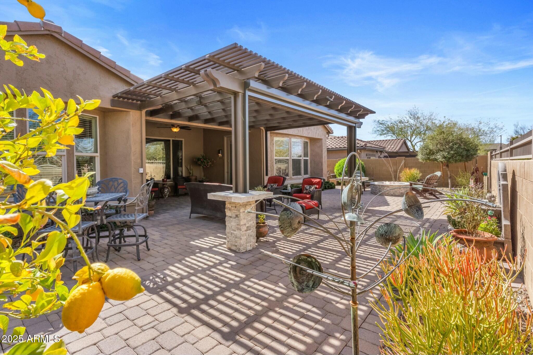 2022 West Steed Ridge Phoenix, AZ 85085 - Photo 48 of 85 a view of a patio with table and chairs and potted plants
