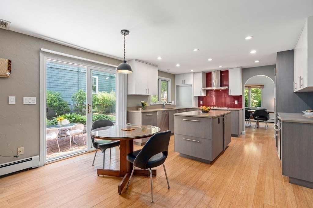 95 Wood End Road Newton, MA 02461 - Photo 11 of 28 a kitchen with a table chairs refrigerator and cabinets