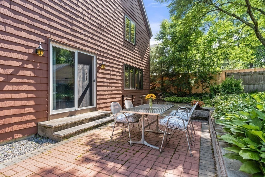 95 Wood End Road Newton, MA 02461 - Photo 12 of 28 a view of backyard with a table and chairs and potted plants