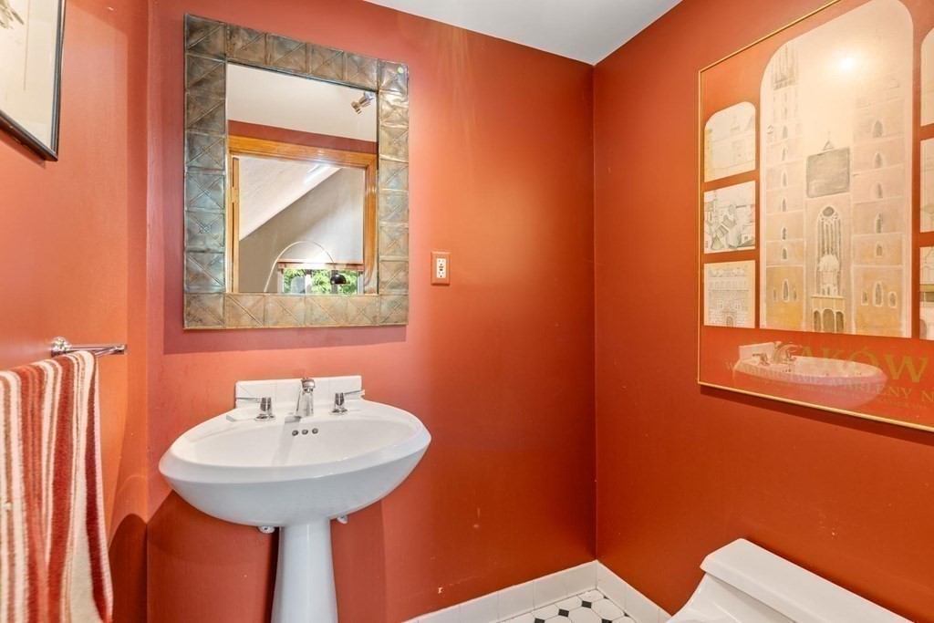 95 Wood End Road Newton, MA 02461 - Photo 14 of 28 a bathroom with a sink a mirror and a window