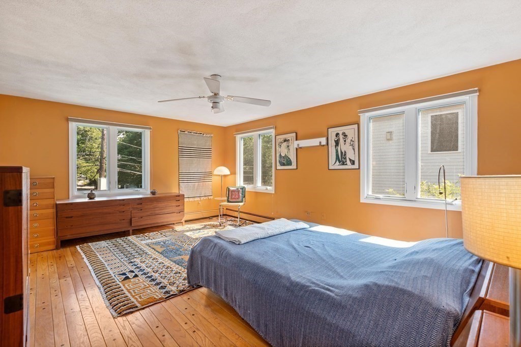 95 Wood End Road Newton, MA 02461 - Photo 17 of 28 a bedroom with a bed and wooden floor