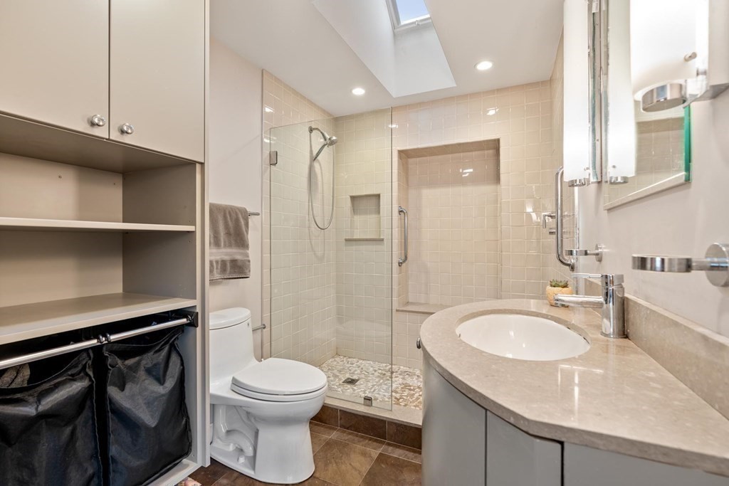 95 Wood End Road Newton, MA 02461 - Photo 18 of 28 a bathroom with a sink a toilet and shower