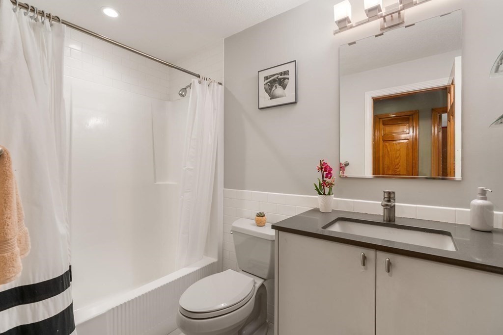 95 Wood End Road Newton, MA 02461 - Photo 21 of 28 a bathroom with a sink a toilet and shower