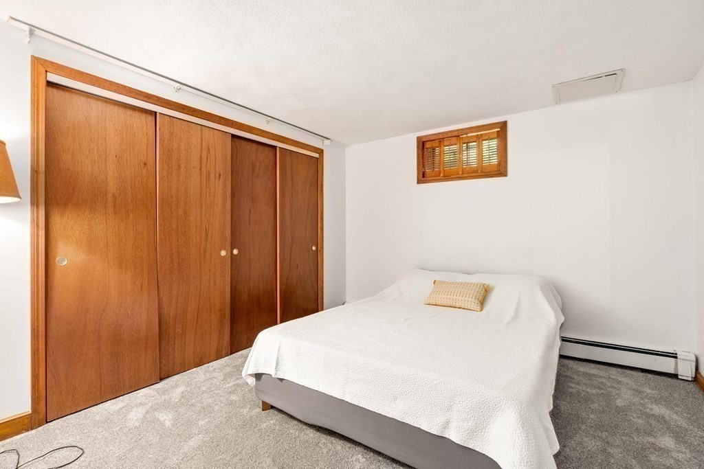 95 Wood End Road Newton, MA 02461 - Photo 23 of 28 a bedroom with a bed and a window