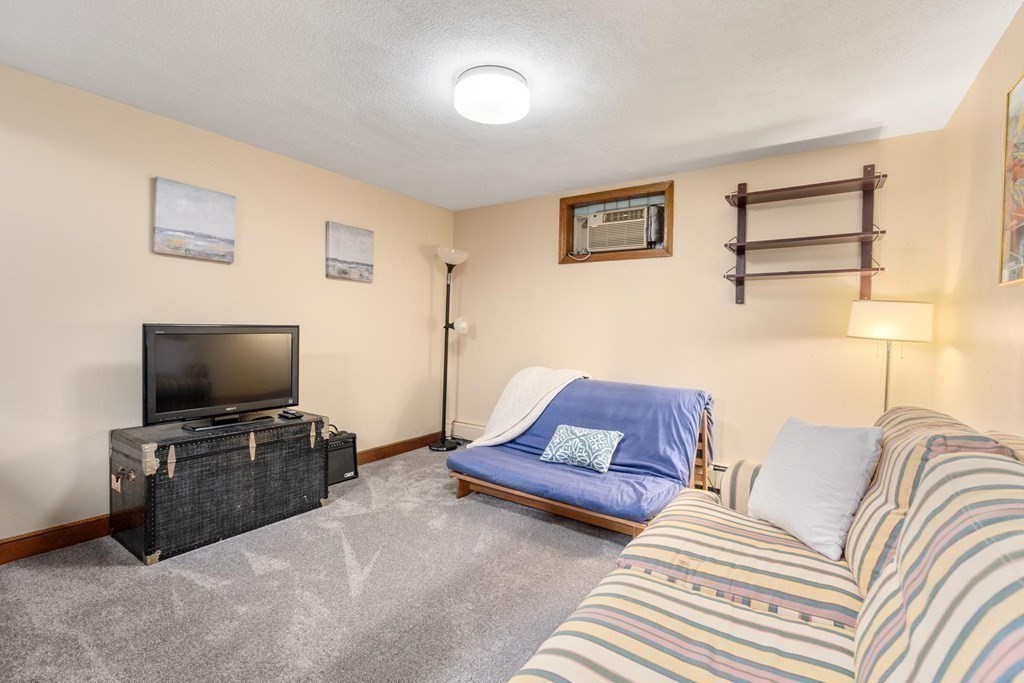 95 Wood End Road Newton, MA 02461 - Photo 24 of 28 a living room with furniture and a flat screen tv