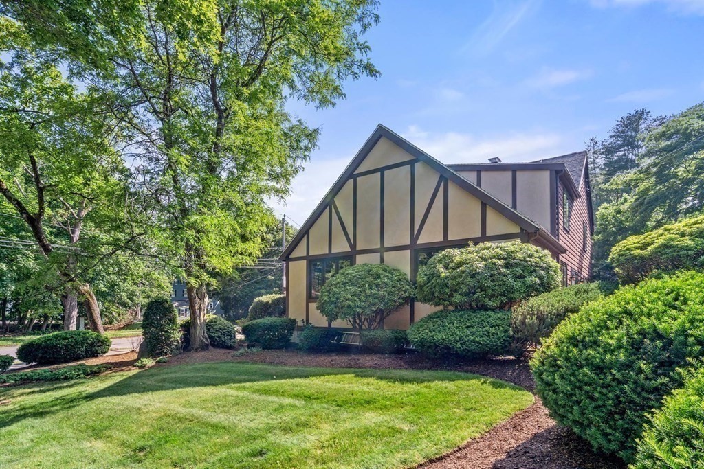 95 Wood End Road Newton, MA 02461 - Photo 27 of 28 a backyard of a house with plants and large trees