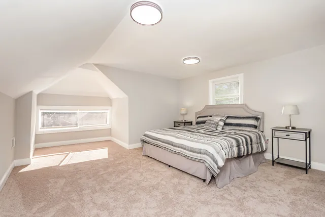 a spacious bedroom with a bed and a window