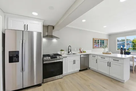 a kitchen with a sink stove and refrigerator