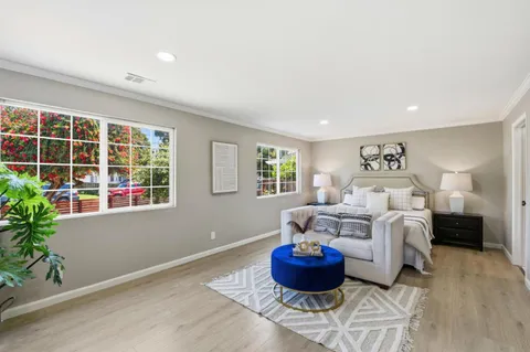 a bedroom with a bed a table and chair