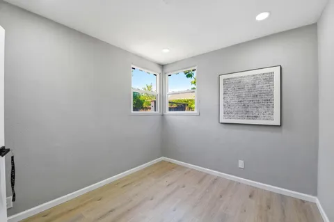 a bedroom with a bed and a chair