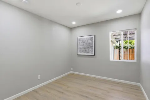wooden floor in a hall with an empty room