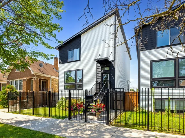 a view of a brick house with large windows