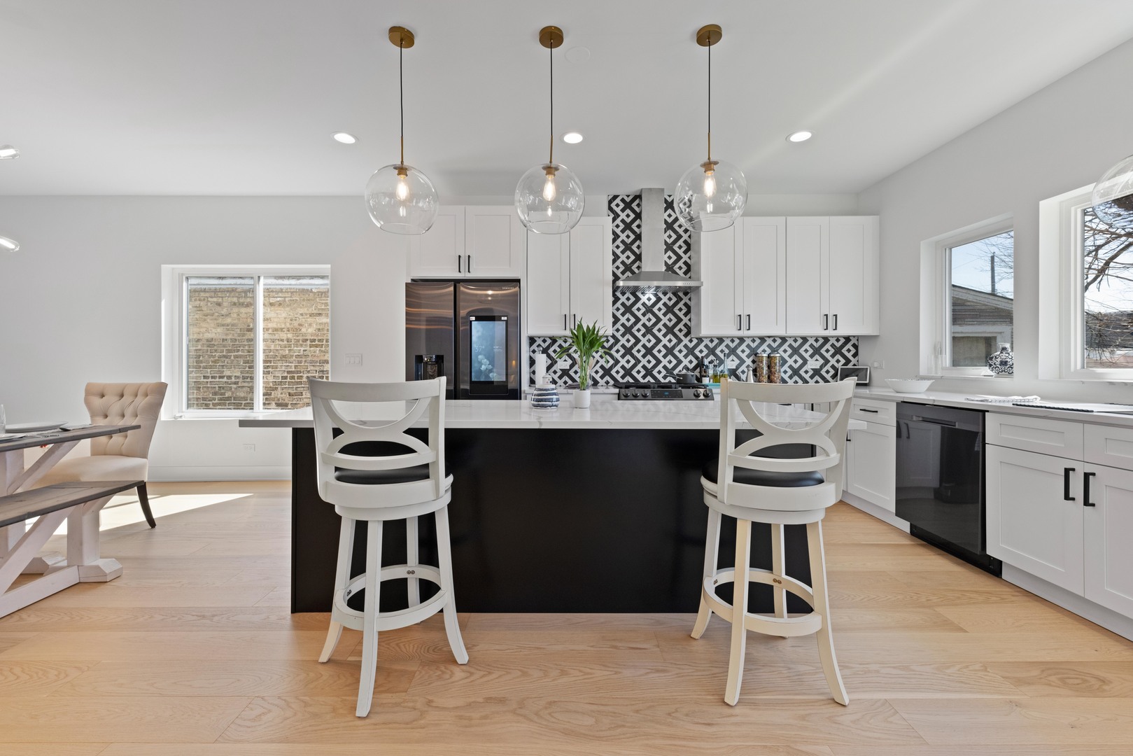 1522 North Leamington Avenue Chicago, IL 60651 - Photo 13 of 37 a kitchen with a dining table chairs a sink and cabinets