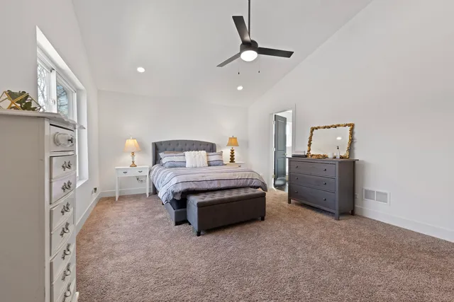 a bedroom with a large bed and a dresser