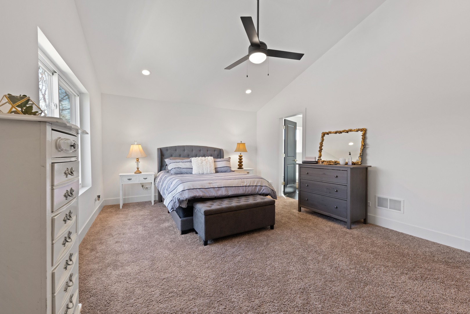 1522 North Leamington Avenue Chicago, IL 60651 - Photo 19 of 37 a bedroom with a bed dresser and a chandelier