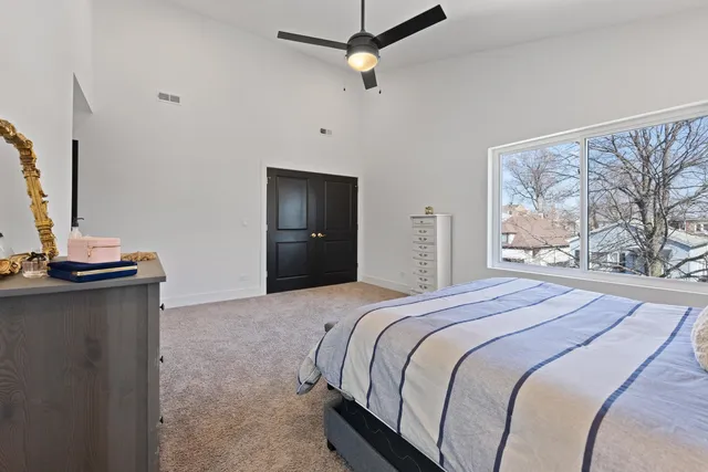 a bedroom with a bed and a mirror