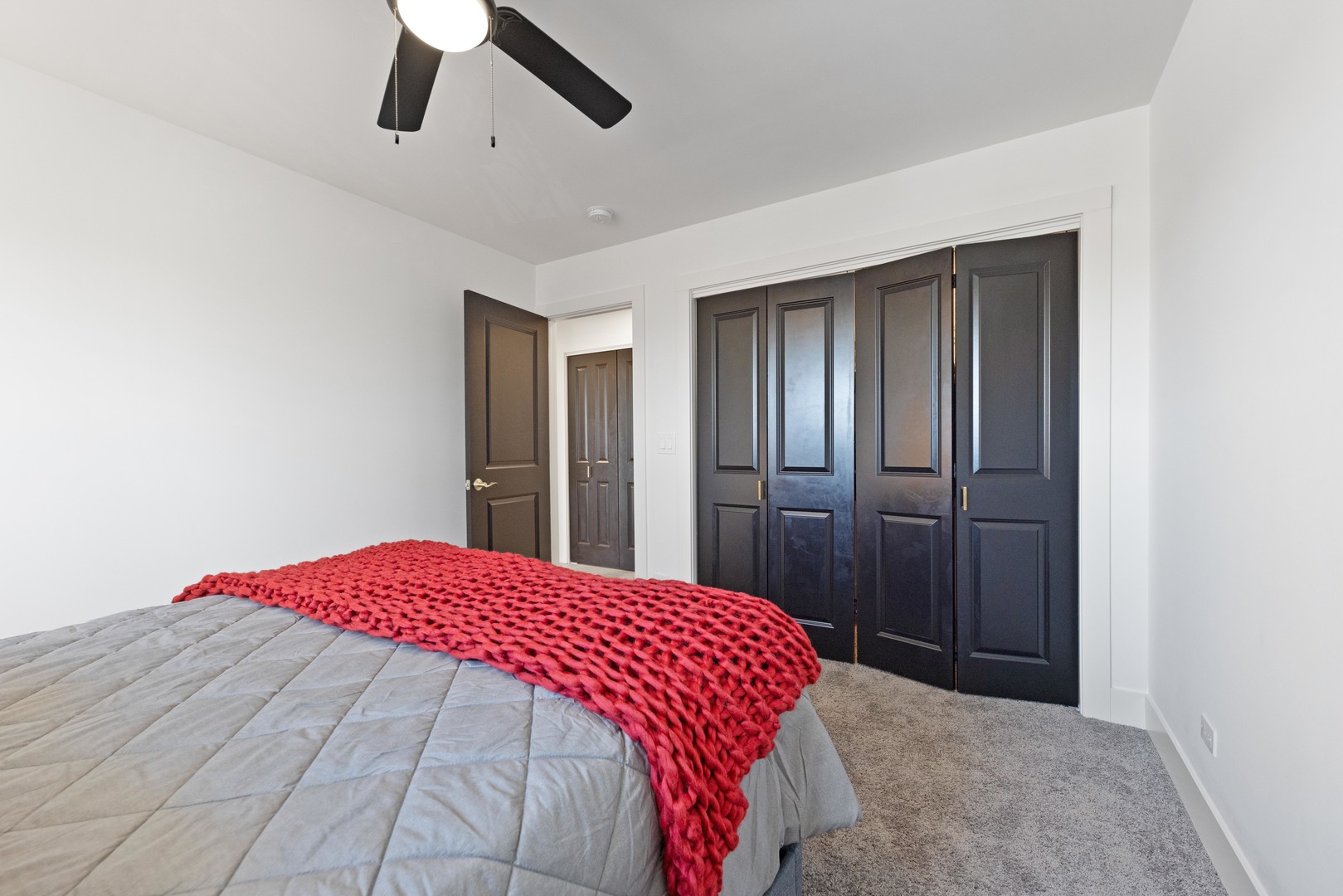 1522 North Leamington Avenue Chicago, IL 60651 - Photo 25 of 37 a bedroom with a large bed and a chandelier