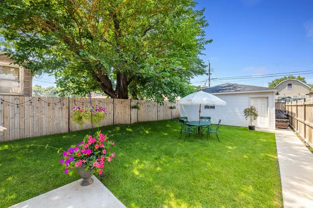 a view of a house with backyard and sitting area