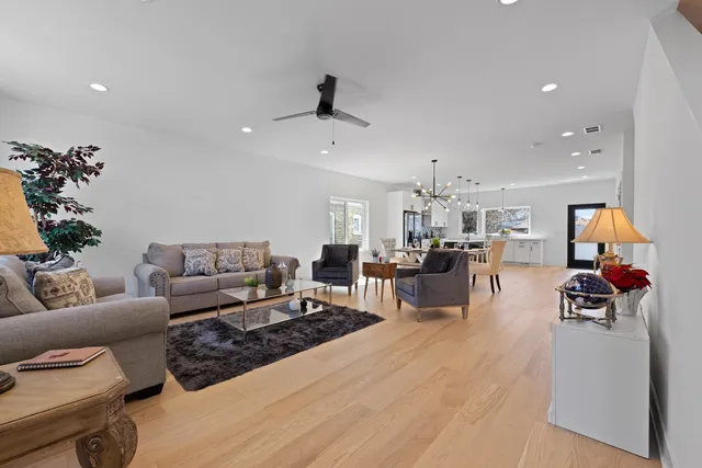 a living room with furniture and a chandelier