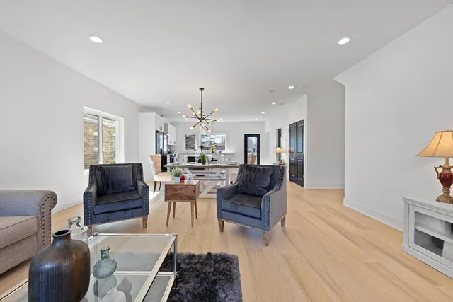 a living room with dining room and wooden floor