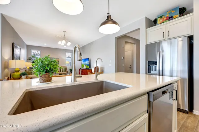 a kitchen with a refrigerator and a sink