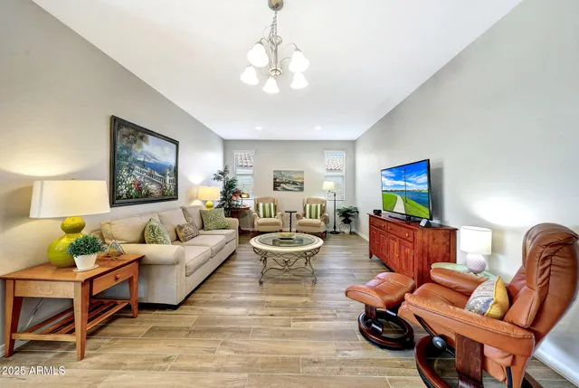 a living room with furniture and a chandelier
