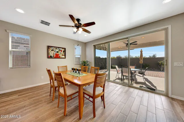 a dining room with furniture a chandelier and wooden floor