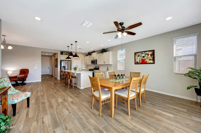 a view of a dining room with furniture and wooden floor