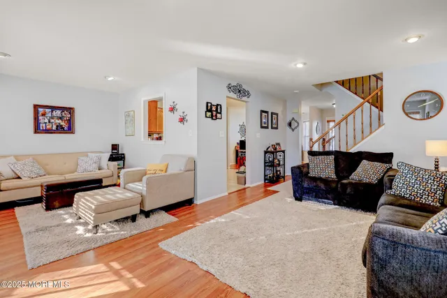 a living room with furniture and a wall painting