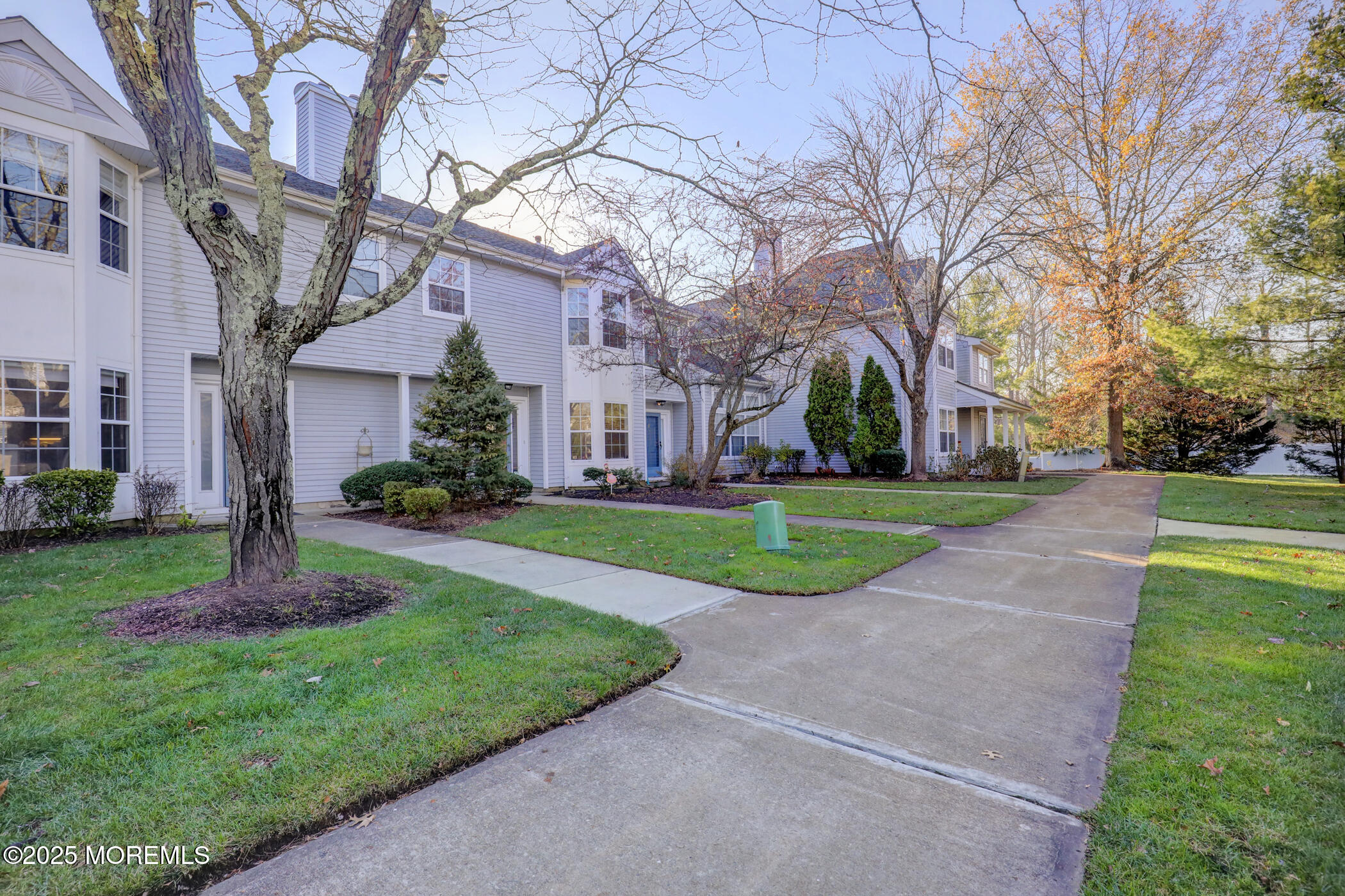 434 Hampton Court, Unit 125 Manalapan, NJ 07726 - Photo 13 of 13 a view of a house with a big yard and large tree