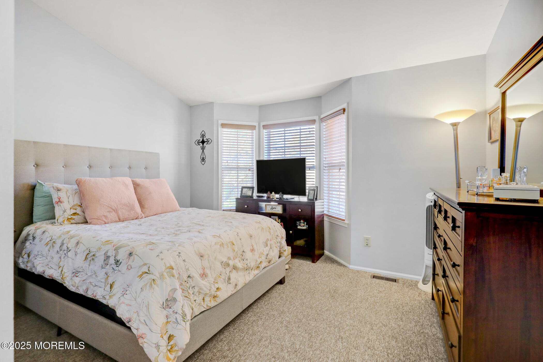 434 Hampton Court, Unit 125 Manalapan, NJ 07726 - Photo 3 of 13 a bedroom with a bed and a television