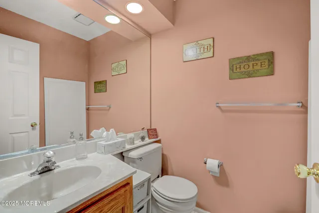 a bathroom with a sink a toilet and a mirror