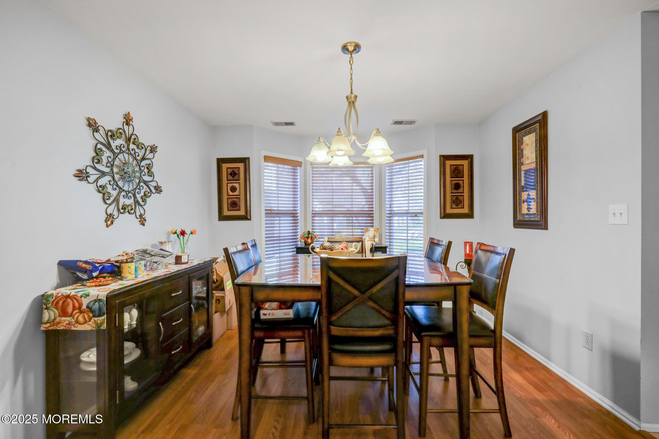 434 Hampton Court, Unit 125 Manalapan, NJ 07726 - Photo 7 of 13 a view of a dining room with furniture window and wooden floor