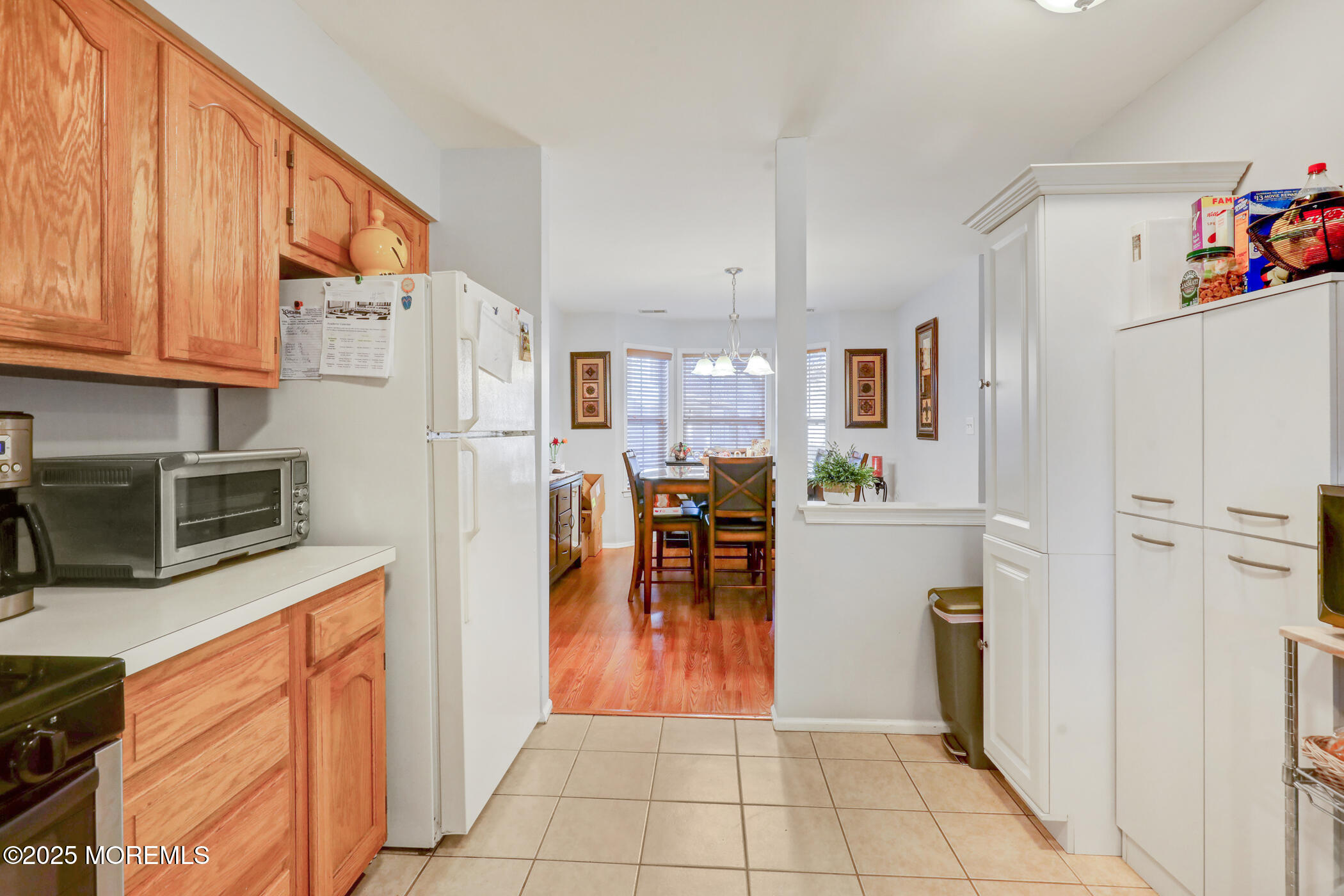 434 Hampton Court, Unit 125 Manalapan, NJ 07726 - Photo 9 of 13 a kitchen with stainless steel appliances a refrigerator sink and cabinets